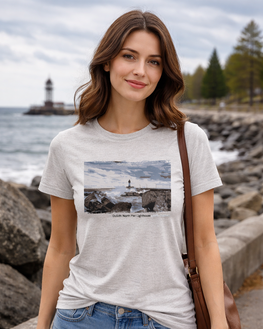 Woman wearing a t-shirt with a lighthouse design by the waterfront