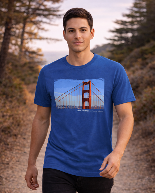 Man wearing a blue t-shirt with a Golden Gate Bridge graphic outdoors.