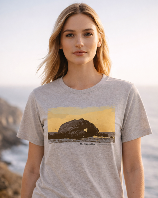 Woman wearing a t-shirt with a scenic print of a rock formation.