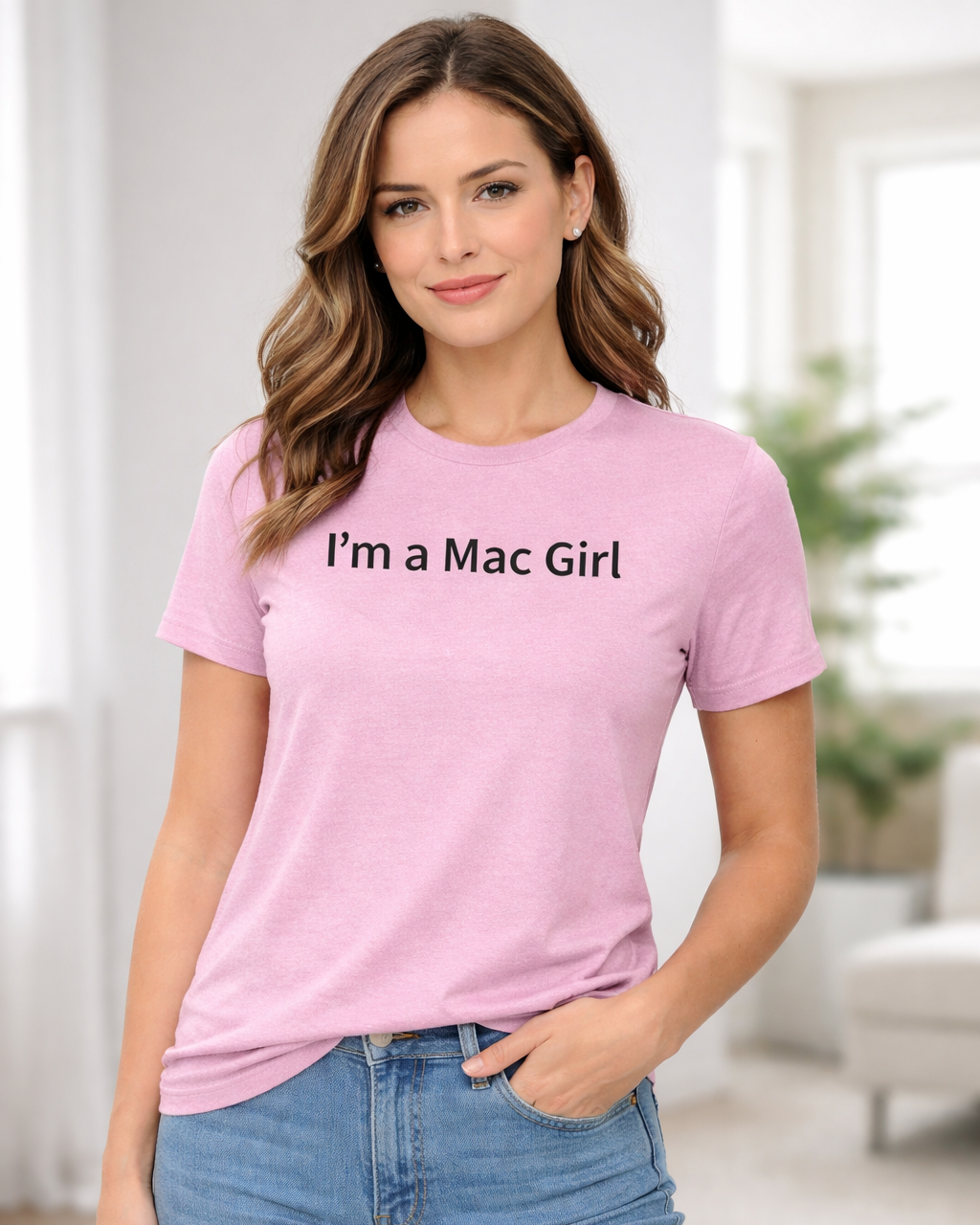 Woman wearing a pink t-shirt with 'I'm a Mac Girl' text in a bright room.
