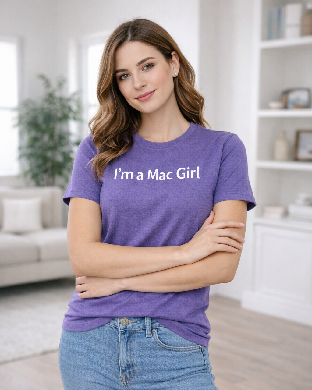 Woman wearing a purple t-shirt with 'I'm a Mac Girl' text in a living room.