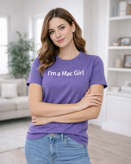 Woman wearing a purple t-shirt with 'I'm a Mac Girl' text in a living room.