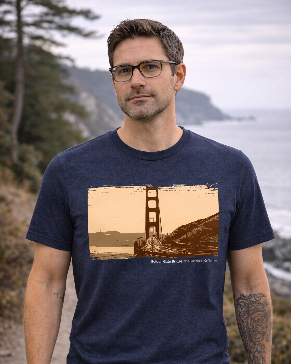 Man wearing a navy blue t-shirt with a Golden Gate Bridge graphic, standing outdoors.