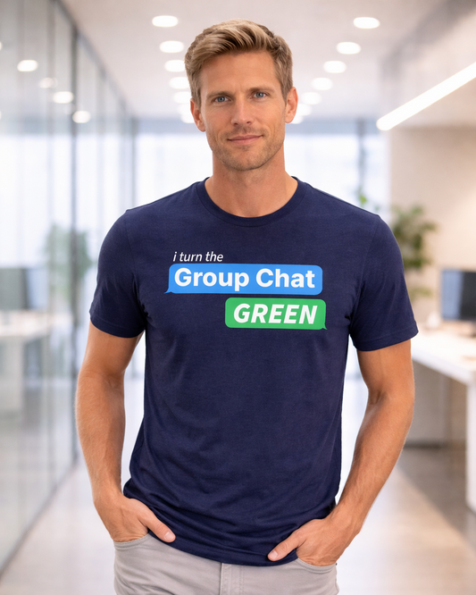 Man wearing a navy blue t-shirt with text in an office setting