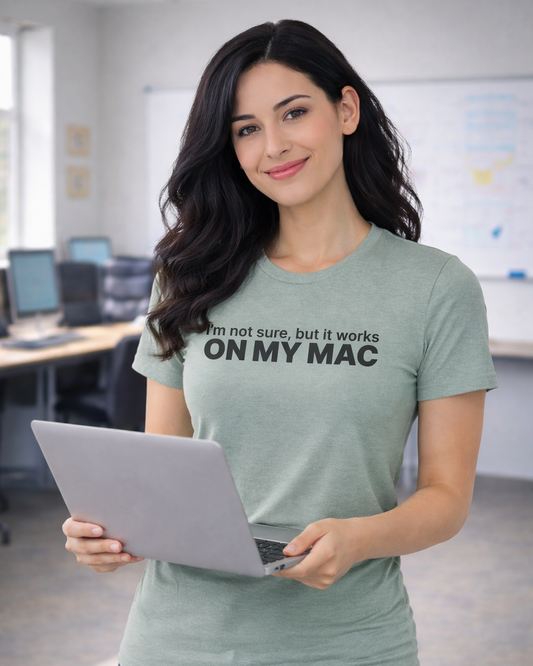 Woman holding a laptop wearing a t-shirt with text in an office setting